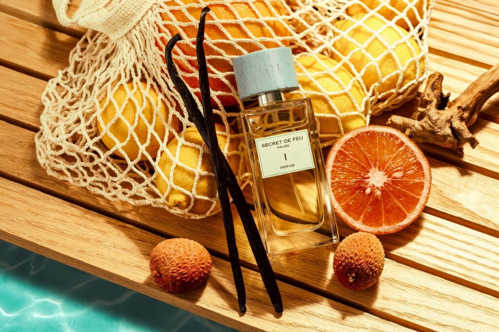 Secret de Feu I with citrus fruit and vanilla pods beside a pool